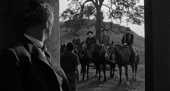 Movie still from “Terror in a Texas Town” (1958), directed by Joseph H. Lewis – A group of men on horses in a field; Medium shot, Low angle