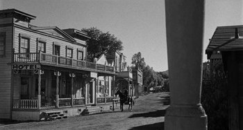 Movie still from “Terror in a Texas Town” (1958), directed by Joseph H. Lewis – An old photo of a horse and rider on a dirt road; Extreme Wide shot, Low angle