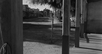 Movie still from “Terror in a Texas Town” (1958), directed by Joseph H. Lewis – An old photo of an old western town; Wide shot, Over the shoulder angle