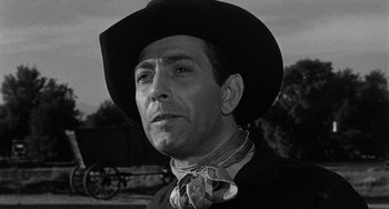 Movie still from “Terror in a Texas Town” (1958), directed by Joseph H. Lewis – A black and white photo of a man wearing a cowboy hat; Close Up shot, Low angle