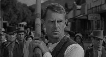 Movie still from “Terror in a Texas Town” (1958), directed by Joseph H. Lewis – An old black and white photo of a man holding a baseball bat; Close Up shot, Low angle