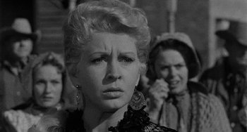 Movie still from “Terror in a Texas Town” (1958), directed by Joseph H. Lewis – A black - and - white photo of a woman in a black dress; Close Up shot, Over the shoulder angle