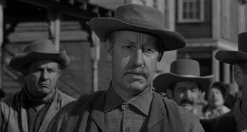 Movie still from “Terror in a Texas Town” (1958), directed by Joseph H. Lewis – A man with a hat and a mustache; Close Up shot, Over the shoulder angle