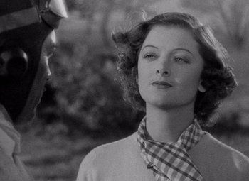 Movie still from “Test Pilot” (1938), directed by Victor Fleming – A black and white photo of a woman in a plaid tie; Close Up shot, Over the shoulder angle