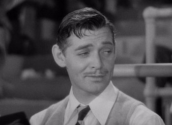 Movie still from “Test Pilot” (1938), directed by Victor Fleming – A man that is wearing a suit and a tie; Close Up shot, Over the shoulder angle