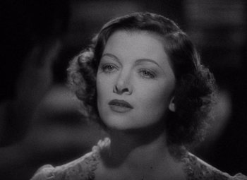 Movie still from “Test Pilot” (1938), directed by Victor Fleming – A black - and - white photo of a woman in a dress; Close Up shot, High angle