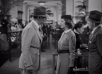 Movie still from “Test Pilot” (1938), directed by Victor Fleming – A man and a woman talking in a restaurant; Medium shot, High angle