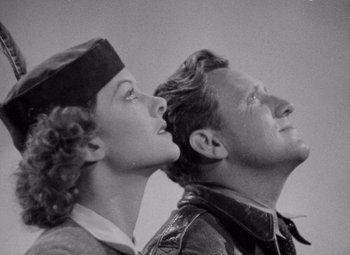 Movie still from “Test Pilot” (1938), directed by Victor Fleming – An old black and white photo of a man and a woman; Close Up shot, Low angle
