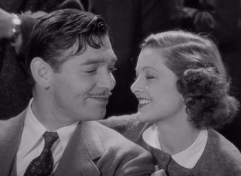 Movie still from “Test Pilot” (1938), directed by Victor Fleming – A man and a woman smiling at each other; Close Up shot, High angle