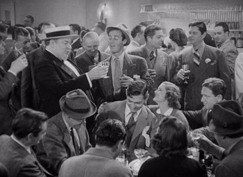 Movie still from “Test Pilot” (1938), directed by Victor Fleming – A group of men and women sitting at a table; Medium shot, High angle