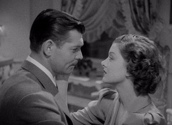 Movie still from “Test Pilot” (1938), directed by Victor Fleming – A man and a woman looking at one another; Close Up shot, Over the shoulder angle