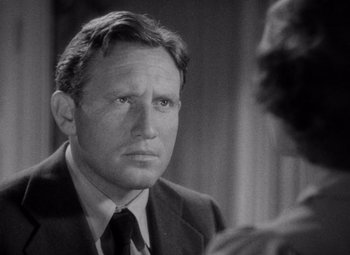 Movie still from “Test Pilot” (1938), directed by Victor Fleming – A man in a suit and tie looking at a woman in a dress; Close Up shot, Over the shoulder angle