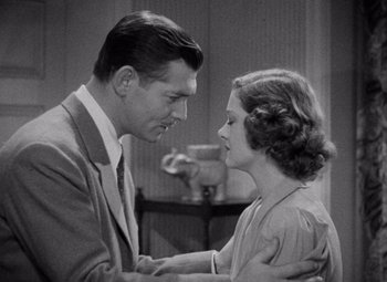 Movie still from “Test Pilot” (1938), directed by Victor Fleming – A man and a woman looking at one another; Medium shot, High angle