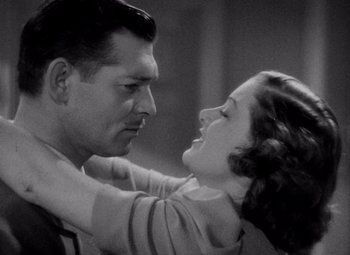 Movie still from “Test Pilot” (1938), directed by Victor Fleming – A man and a woman embracing each other in a black and white photo; Close Up shot, Low angle