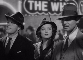 Movie still from “Test Pilot” (1938), directed by Victor Fleming – A group of people standing next to each other wearing hats; Medium shot, Low angle