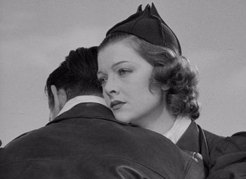 Movie still from “Test Pilot” (1938), directed by Victor Fleming – An old photo of a man and a woman hugging; Close Up shot, Low angle