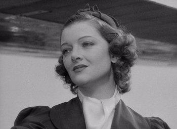Movie still from “Test Pilot” (1938), directed by Victor Fleming – An old photo of a woman in a suit; Close Up shot, Low angle