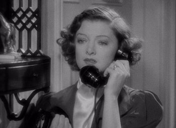 Movie still from “Test Pilot” (1938), directed by Victor Fleming – A woman holding a phone up to her ear; Close Up shot, High angle