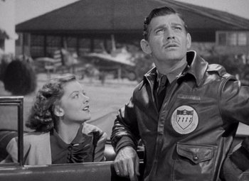 Movie still from “Test Pilot” (1938), directed by Victor Fleming – An old photo of a man and a woman in a car; Medium shot, Low angle