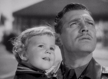 Movie still from “Test Pilot” (1938), directed by Victor Fleming – An older man holding a young boy in his arms; Close Up shot, Low angle