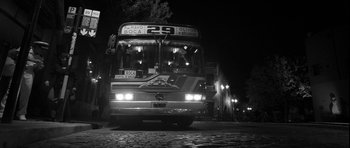 Movie still from “Tetro” (2009), directed by Francis Ford Coppola – A black - and - white photo of a bus at night; Wide shot, Low angle