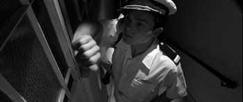 Movie still from “Tetro” (2009), directed by Francis Ford Coppola – Black and white photograph of a man holding a knife; Medium shot, Overhead angle