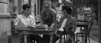 Movie still from “Tetro” (2009), directed by Francis Ford Coppola – A man and a woman sitting at an outdoor table; Medium shot, Low angle