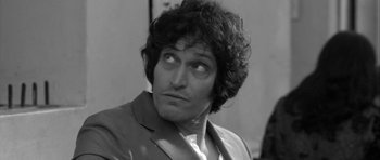 Movie still from “Tetro” (2009), directed by Francis Ford Coppola – Black and white photograph of a man in a suit looking to his left; Close Up shot, Over the shoulder angle