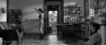 Movie still from “Tetro” (2009), directed by Francis Ford Coppola – A woman is dancing in a room with a dining table in the background; Wide shot, Low angle