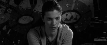 Movie still from “Tetro” (2009), directed by Francis Ford Coppola – Black and white photograph of a young woman in front of a mosaic wall; Close Up shot, Over the shoulder angle