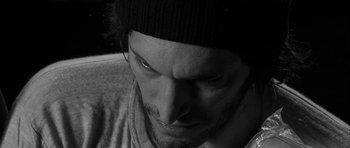 Movie still from “Tetro” (2009), directed by Francis Ford Coppola – Black and white photograph of a man looking down; Extreme Close Up shot, High angle