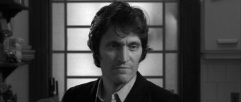 Movie still from “Tetro” (2009), directed by Francis Ford Coppola – Black and white photograph of a man in a suit and tie; Close Up shot, Low angle