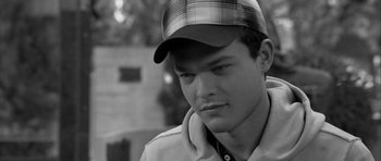 Movie still from “Tetro” (2009), directed by Francis Ford Coppola – Black and white photograph of a man wearing a hat; Close Up shot, Over the shoulder angle
