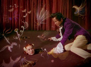 Movie still from “Tetro” (2009), directed by Francis Ford Coppola – A man and a woman in a purple shirt and white dress; Medium shot, High angle