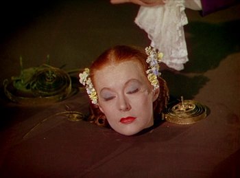 Movie still from “Tetro” (2009), directed by Francis Ford Coppola – A woman with red hair and flowers in her hair is laying on the ground; Close Up shot, High angle