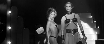 Movie still from “Tetro” (2009), directed by Francis Ford Coppola – A black and white photo of a woman and a man; Medium shot, Low angle