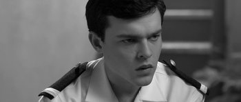 Movie still from “Tetro” (2009), directed by Francis Ford Coppola – Black and white photograph of a young man in uniform; Close Up shot, High angle