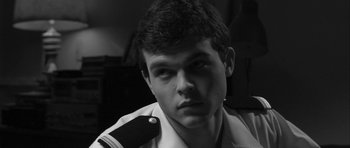 Movie still from “Tetro” (2009), directed by Francis Ford Coppola – A young man in a military uniform stares into the camera; Close Up shot, High angle