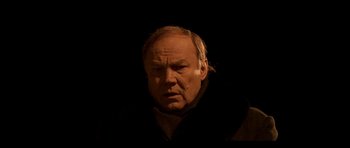 Movie still from “Tetro” (2009), directed by Francis Ford Coppola – An old man with a beard and a jacket on; Close Up shot, High angle