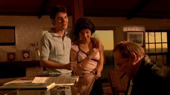 Movie still from “Tetro” (2009), directed by Francis Ford Coppola – A man and a woman standing at a table; Medium shot, Low angle