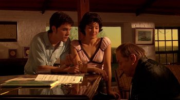 Movie still from “Tetro” (2009), directed by Francis Ford Coppola – A group of people sitting around a table; Medium shot, High angle
