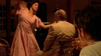 Movie still from “Tetro” (2009), directed by Francis Ford Coppola – An older man and woman are sitting at a piano; Medium shot, Over the shoulder angle