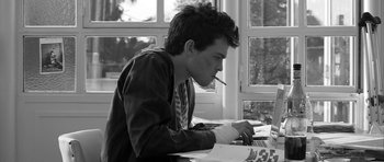 Movie still from “Tetro” (2009), directed by Francis Ford Coppola – A man sitting at a table using a computer; Close Up shot, Low angle