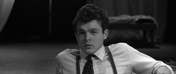 Movie still from “Tetro” (2009), directed by Francis Ford Coppola – Black and white photograph of a young man wearing a tie; Close Up shot, High angle
