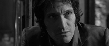 Movie still from “Tetro” (2009), directed by Francis Ford Coppola – Black and white photograph of a man looking at the camera; Close Up shot, Low angle