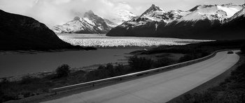 Movie still from “Tetro” (2009), directed by Francis Ford Coppola – A black and white photo of a lake and mountains; Extreme Wide shot, High angle
