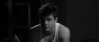 Movie still from “Tetro” (2009), directed by Francis Ford Coppola – Black and white photograph of a young man in a white tank top; Close Up shot, High angle