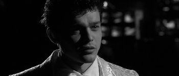 Movie still from “Tetro” (2009), directed by Francis Ford Coppola – Black and white photograph of a young man in a white shirt; Close Up shot, Over the shoulder angle