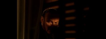 Movie still from “Tetro” (2009), directed by Francis Ford Coppola – A man with a beard is looking out of a window; Close Up shot, High angle