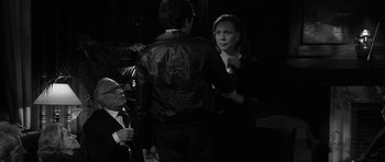 Movie still from “Tetro” (2009), directed by Francis Ford Coppola – A man and a woman are talking to each other in front of an older man; Medium shot, Over the shoulder angle